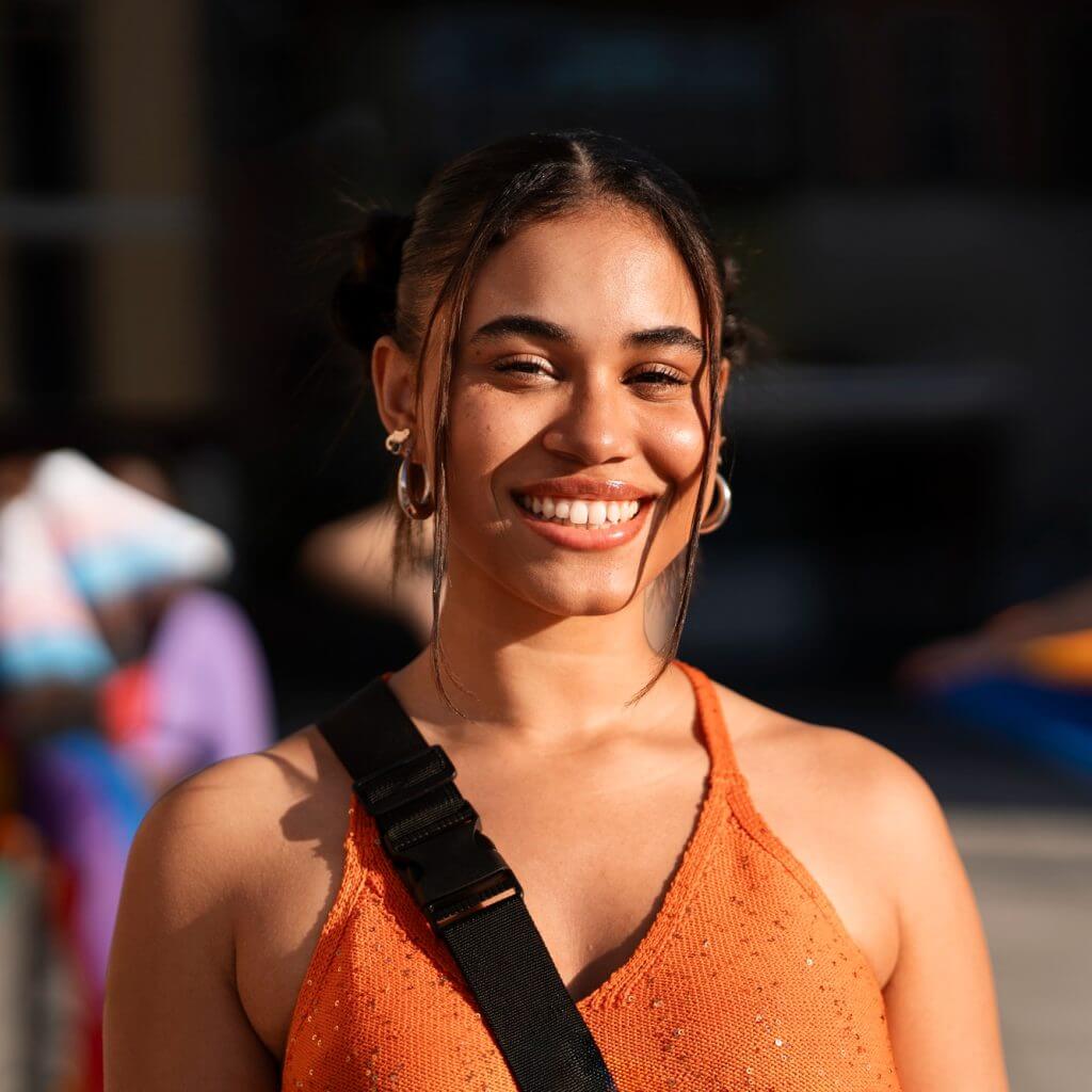 Smiling woman with a shoulder bag outdoors