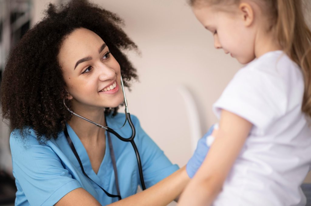 Smiling female doctor with a young patient