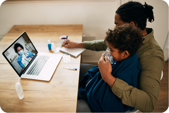 Parent holding a sick child during a telehealth video visit with a doctor