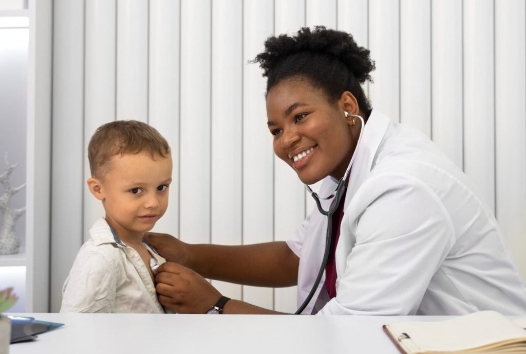 Doctor examining a young boy patient with a stethoscope
