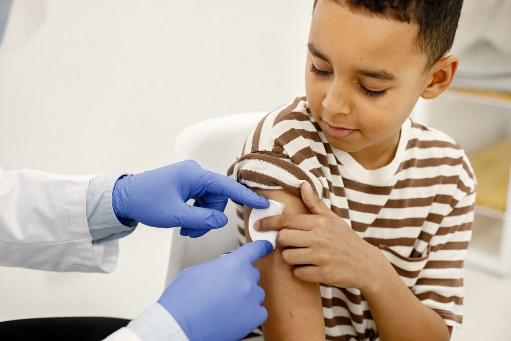Doctor administering a vaccine to a child
