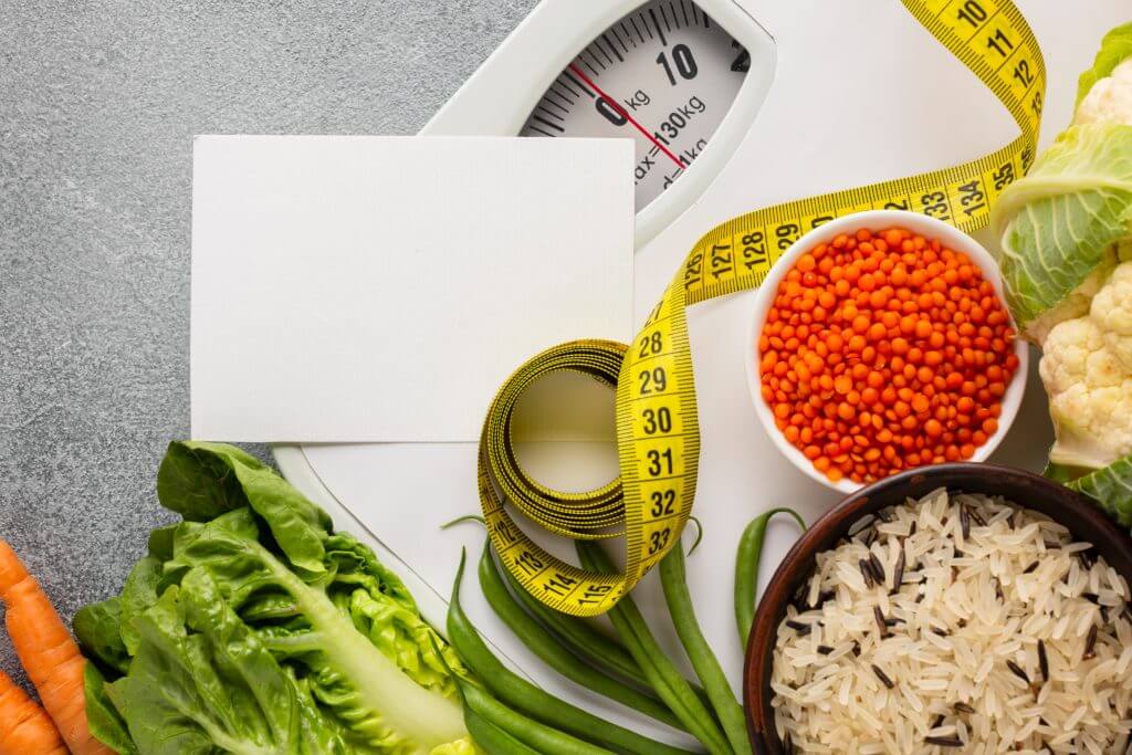 Healthy food and measuring tape representing weight management