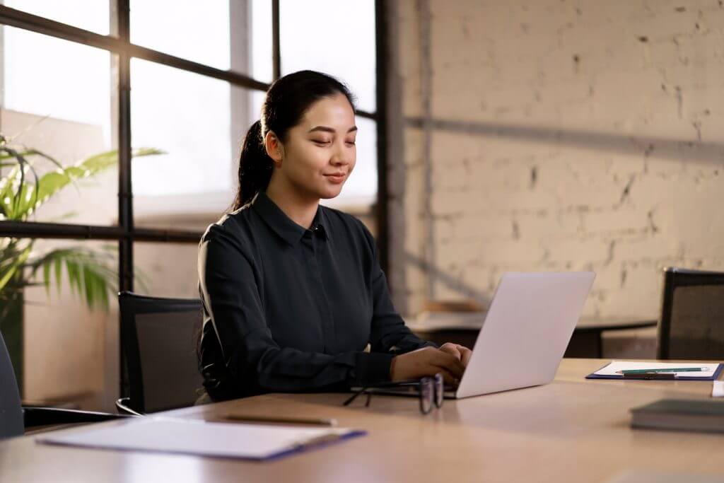 Businesswoman working on a laptop in an office