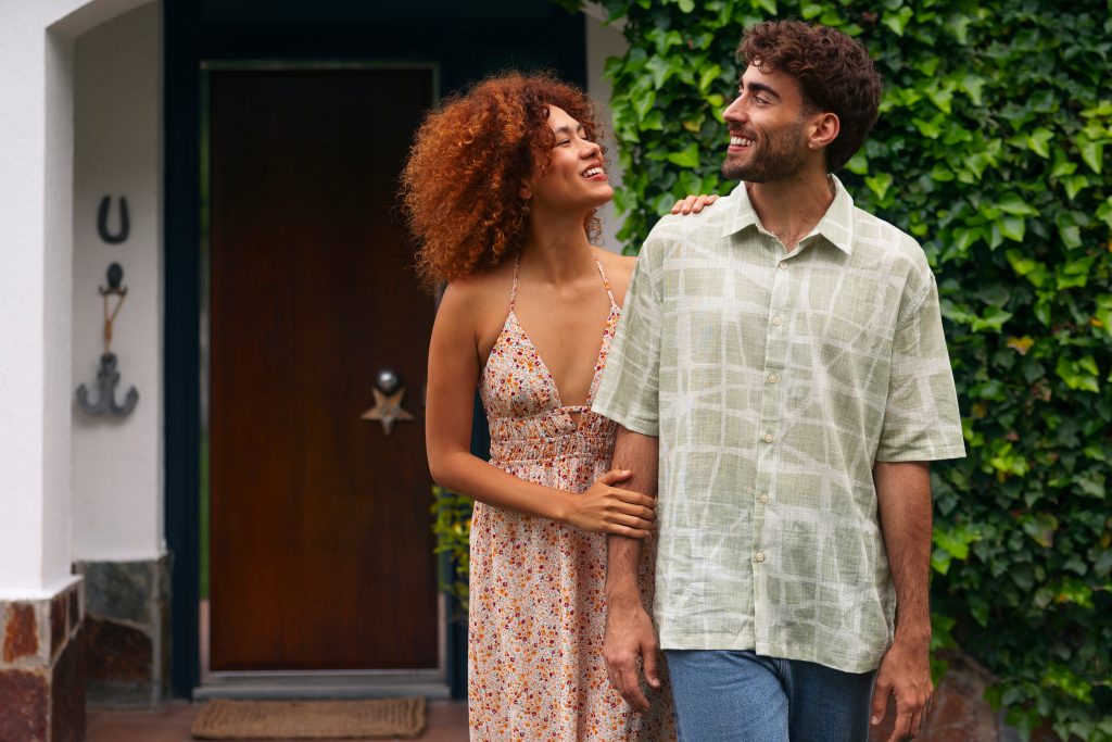 Couple standing together at their front door