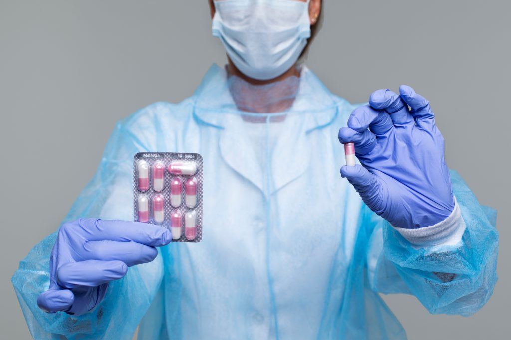 Healthcare provider holding a blister pack of medication