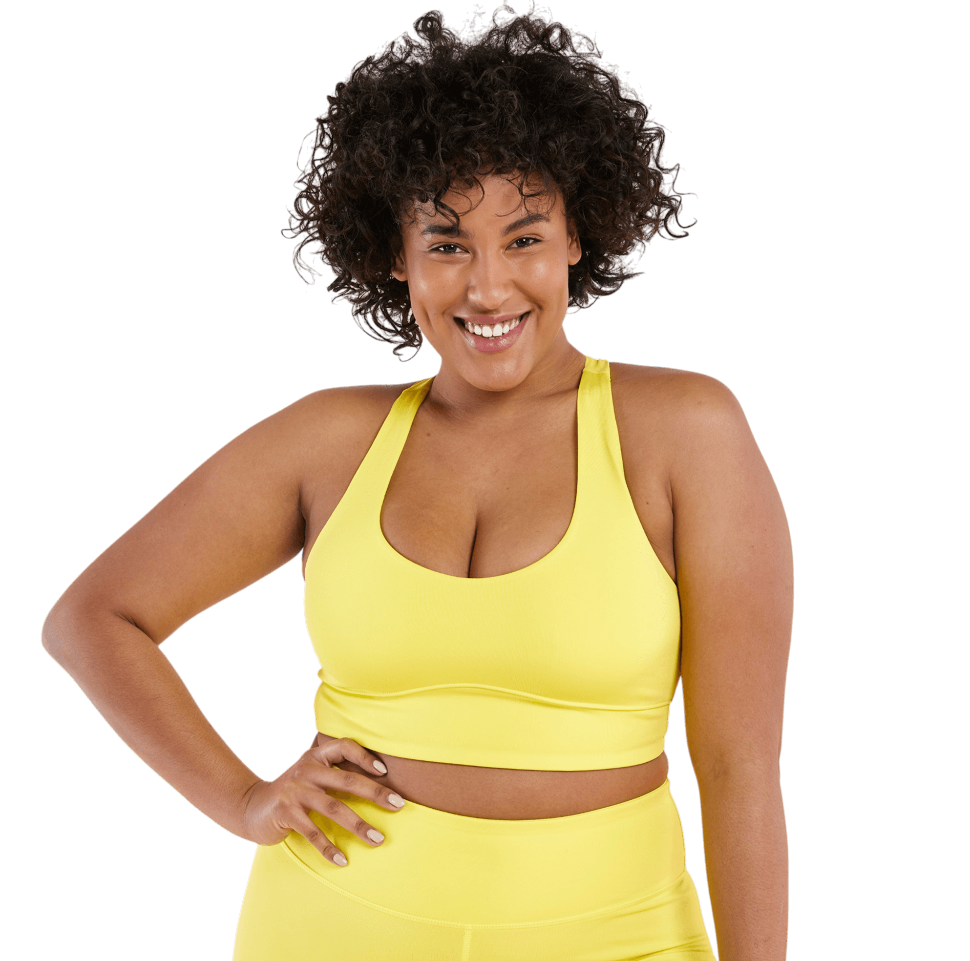 Woman in yellow workout outfit posing confidently