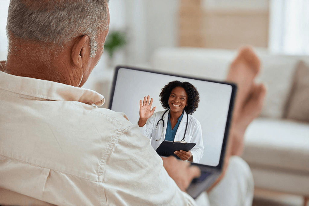 Elderly patient on a telehealth video call with a doctor on a tablet