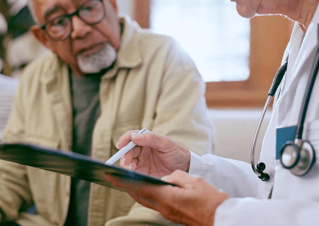 Doctor reviewing a medical report with a male patient